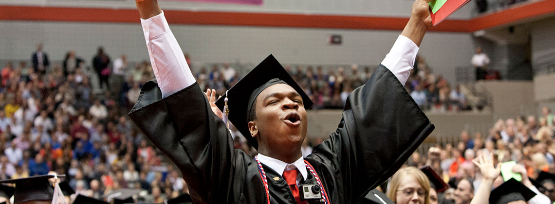 Student celebrating graduation with hands in air https://www.uc.edu